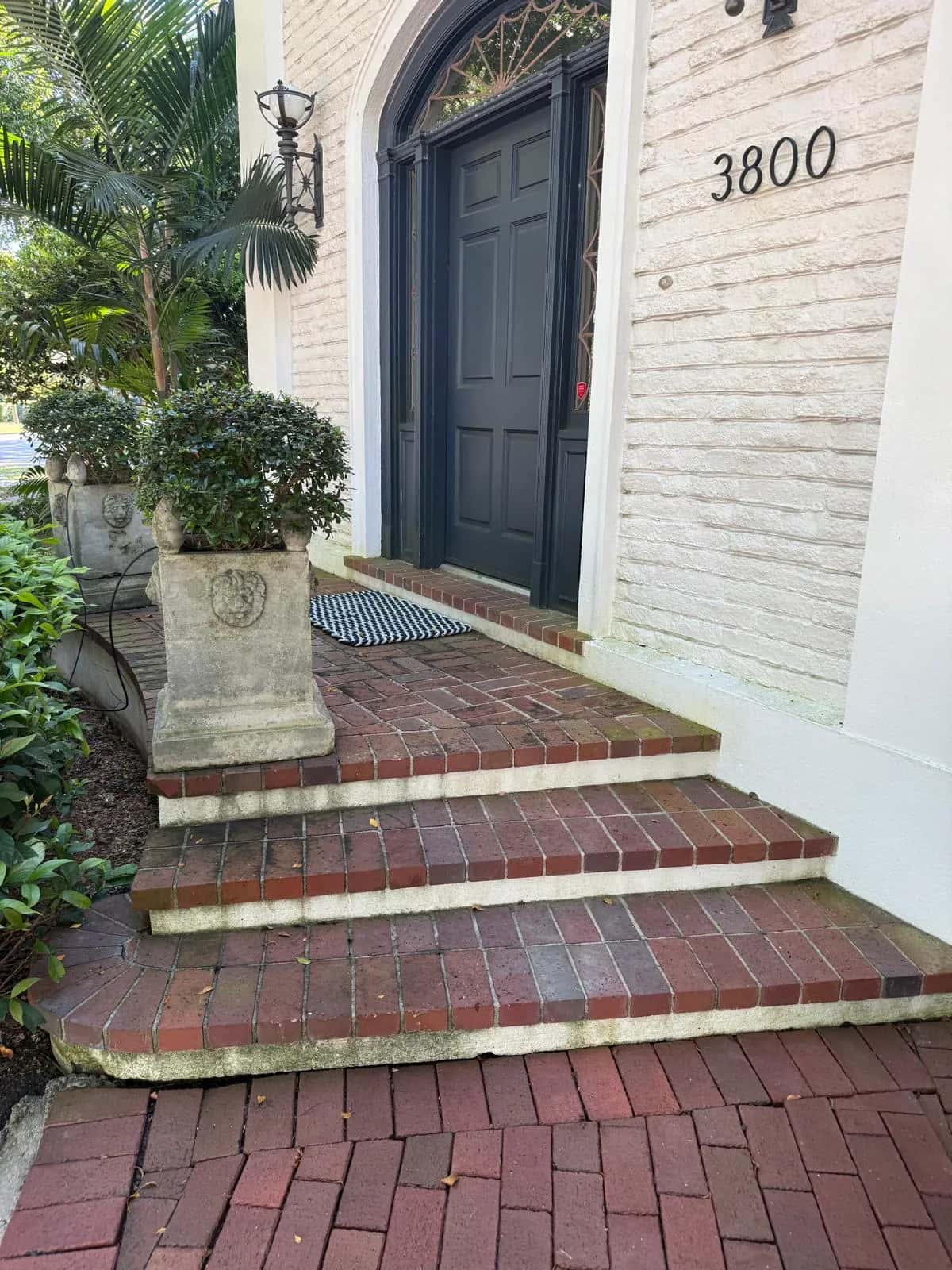 Weathered red brick front steps before cleaning