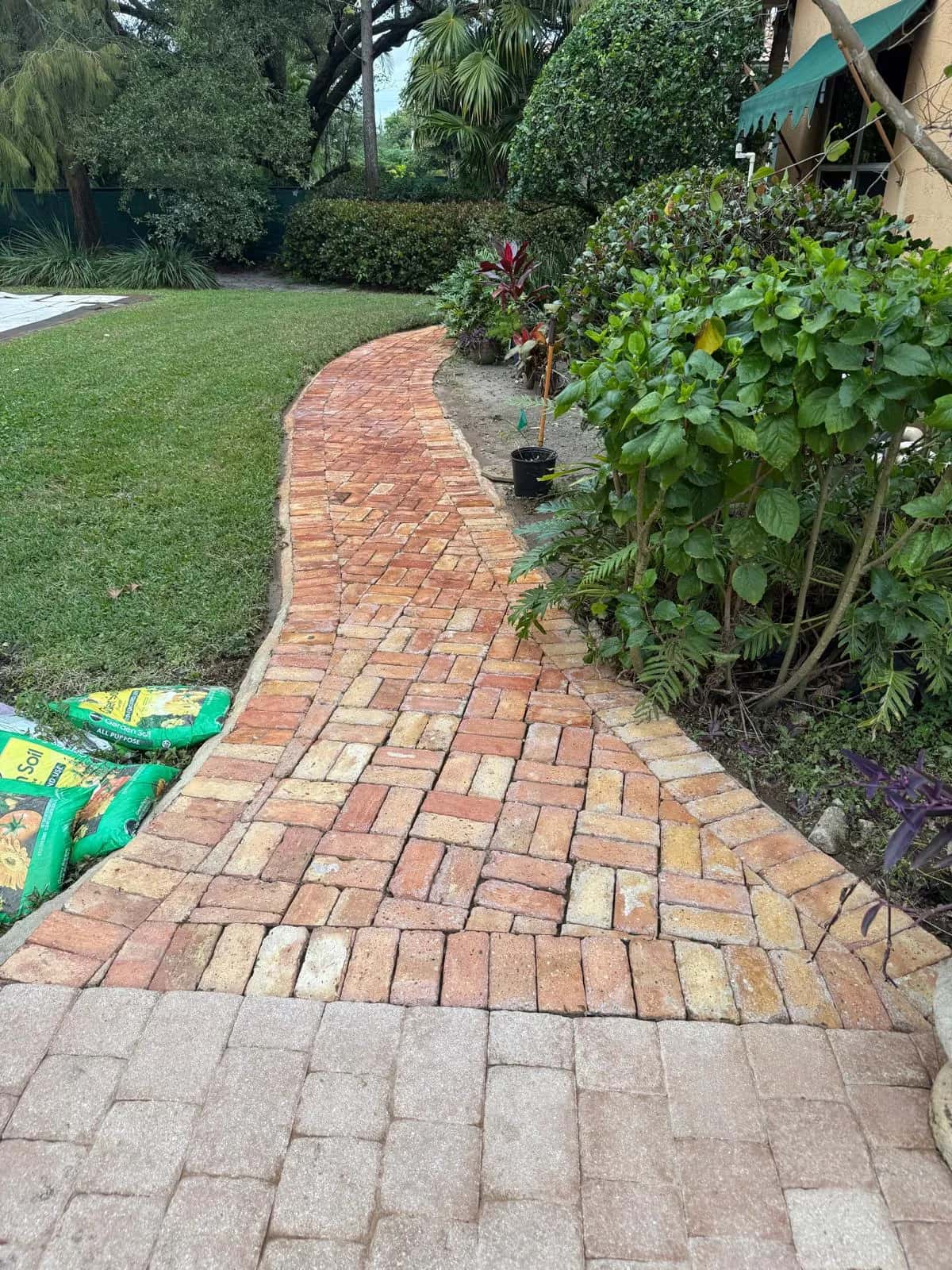 Curving brick garden walkway after pressure cleaning