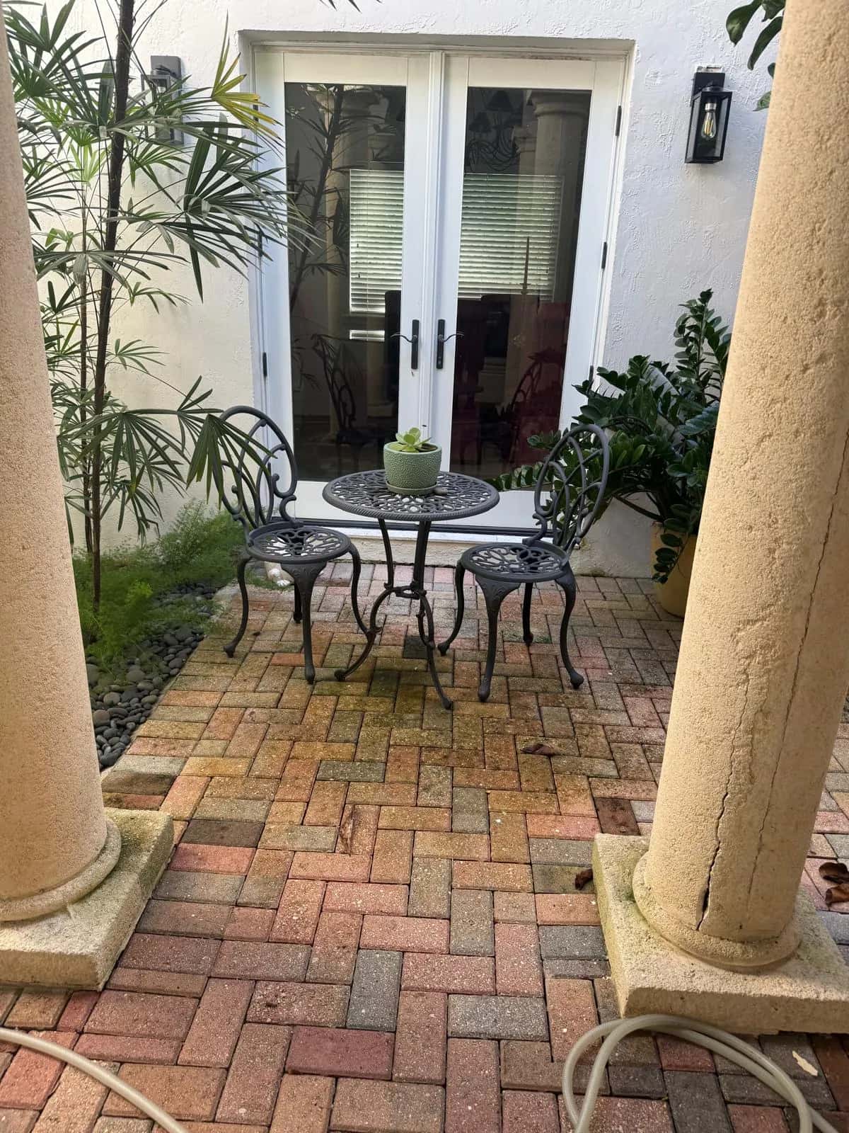 Herringbone paver entry patio dulled by dirt before cleaning