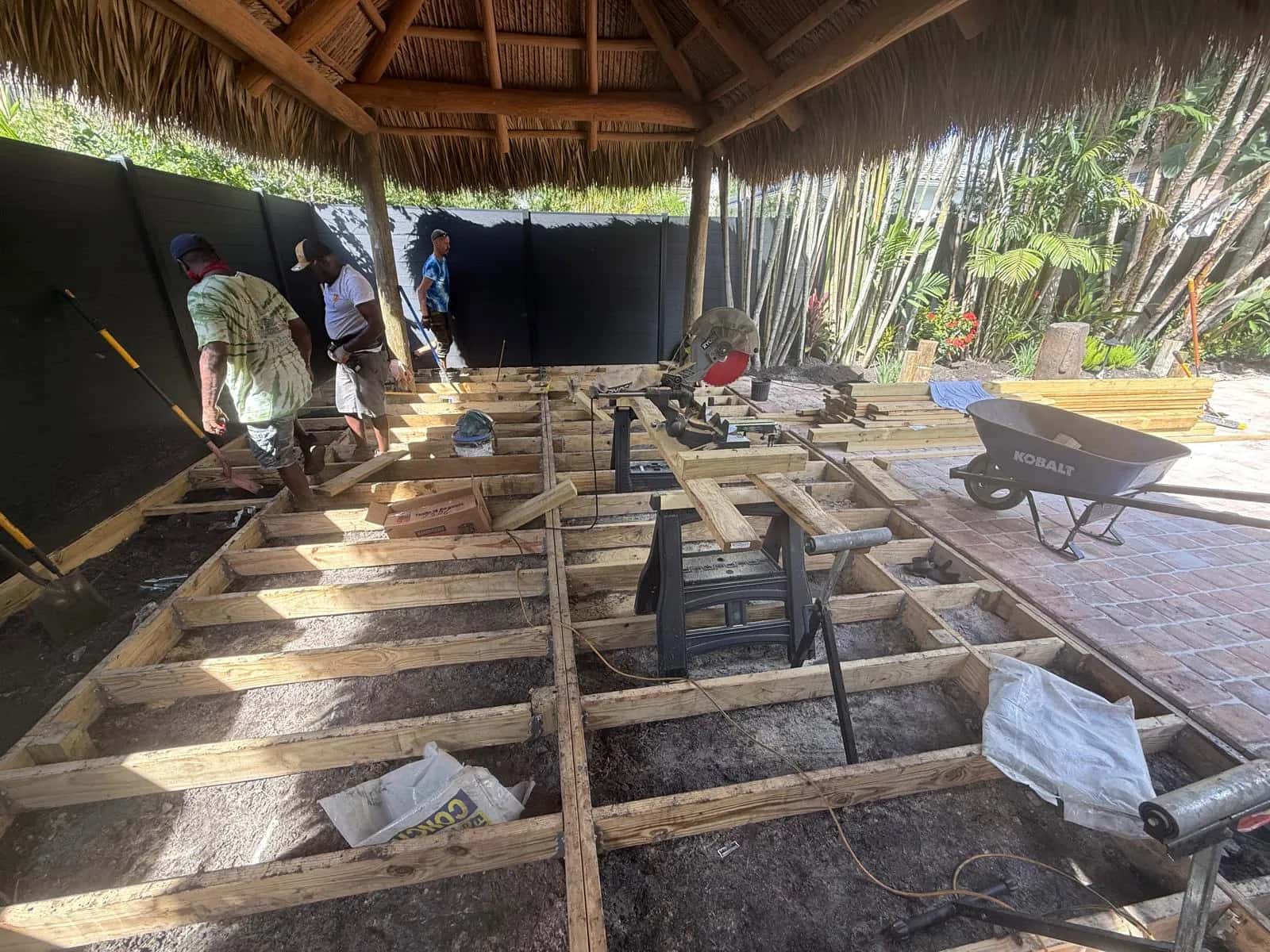 Wood deck framing under a tiki hut in progress