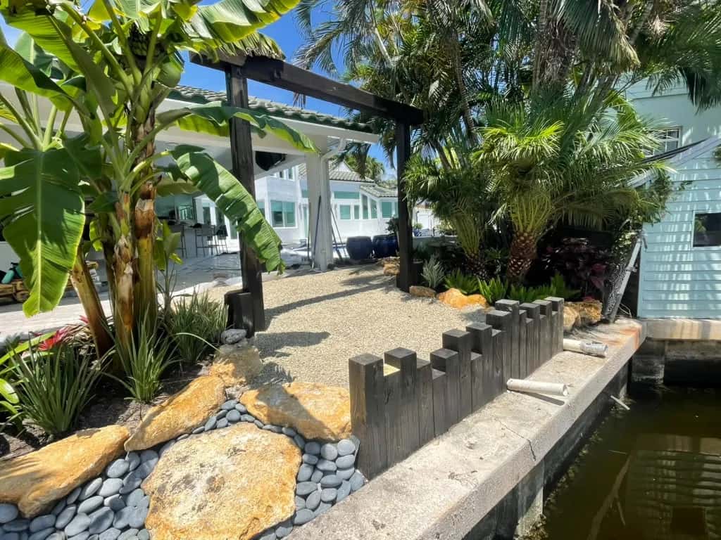 Waterfront tropical landscaping with decorative rock and boulders