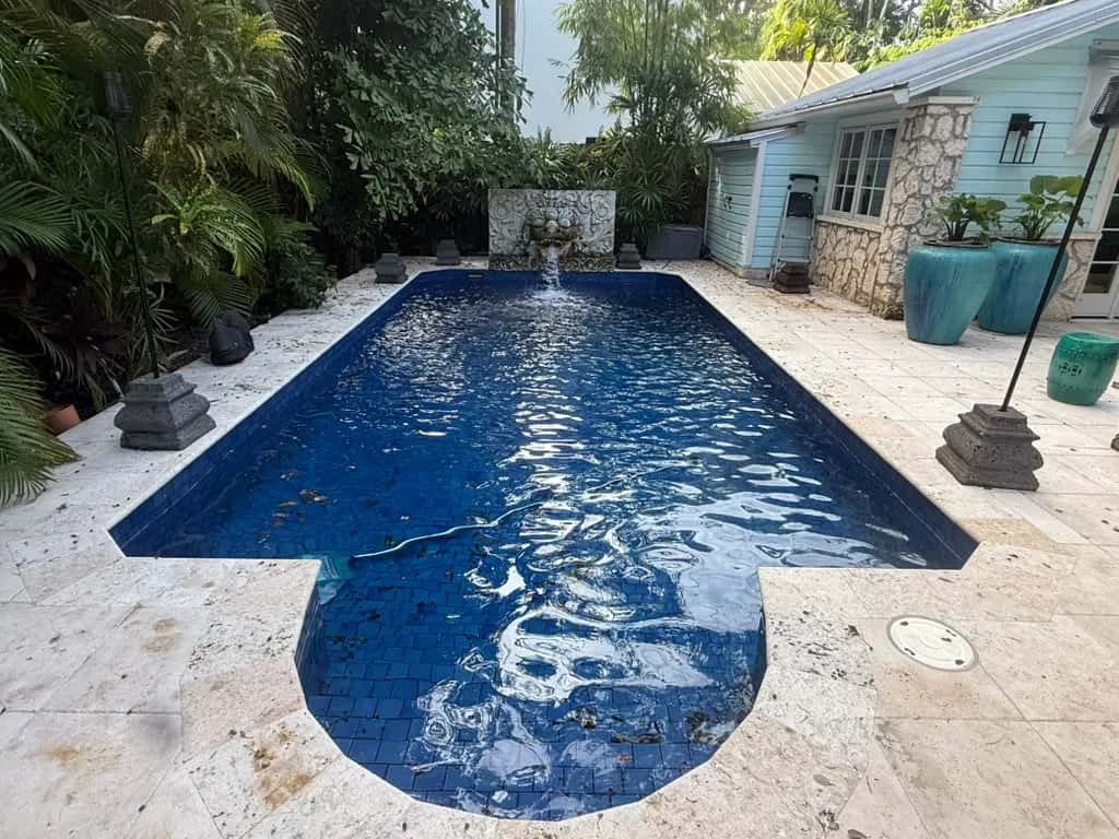 Stained travertine pool deck before cleaning