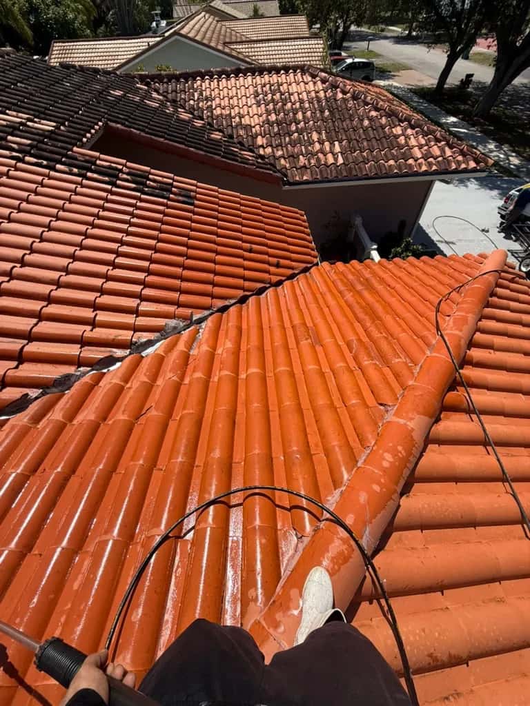 Barrel tile roof being pressure cleaned