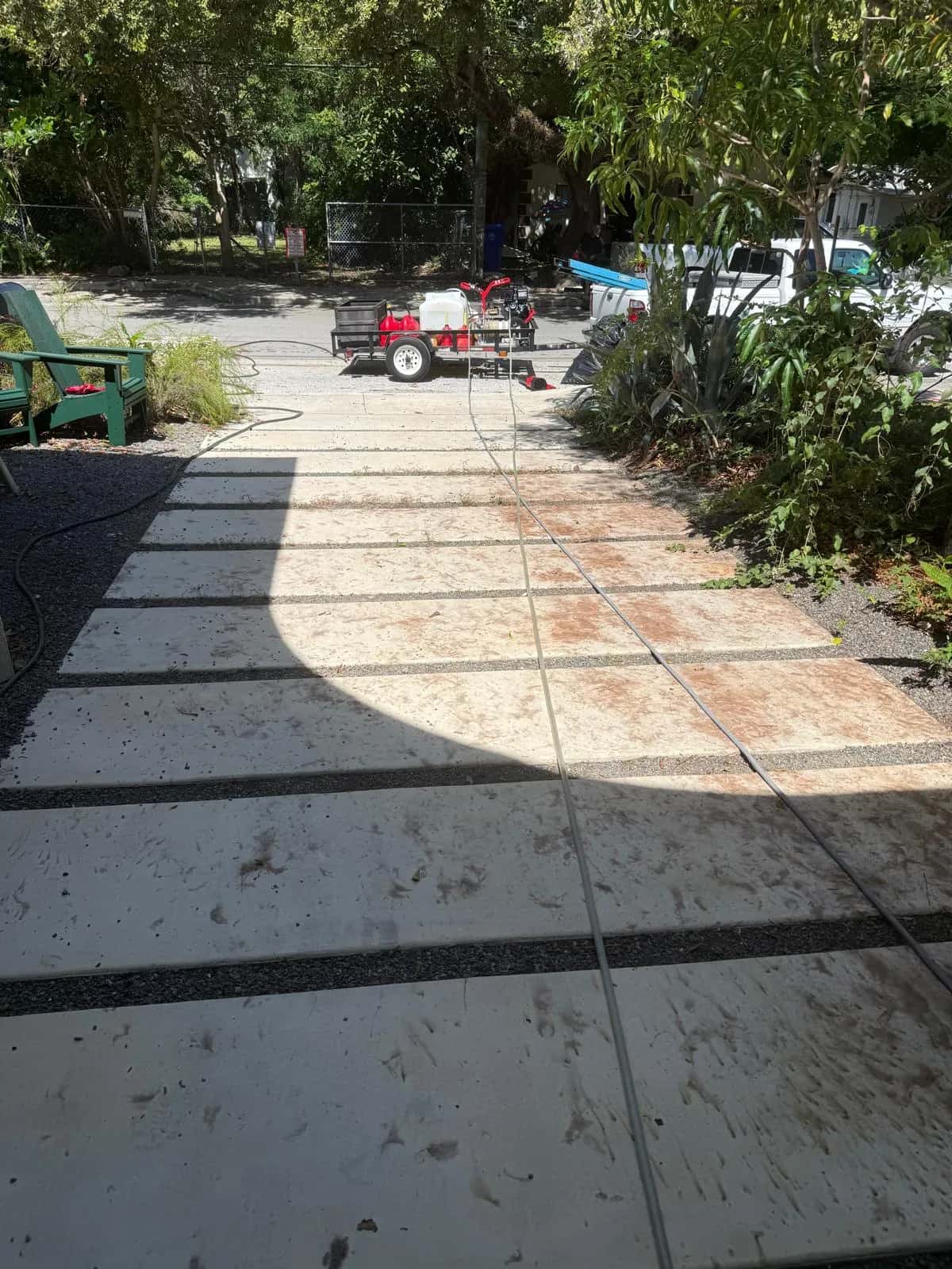 Stained concrete slab walkway before pressure cleaning