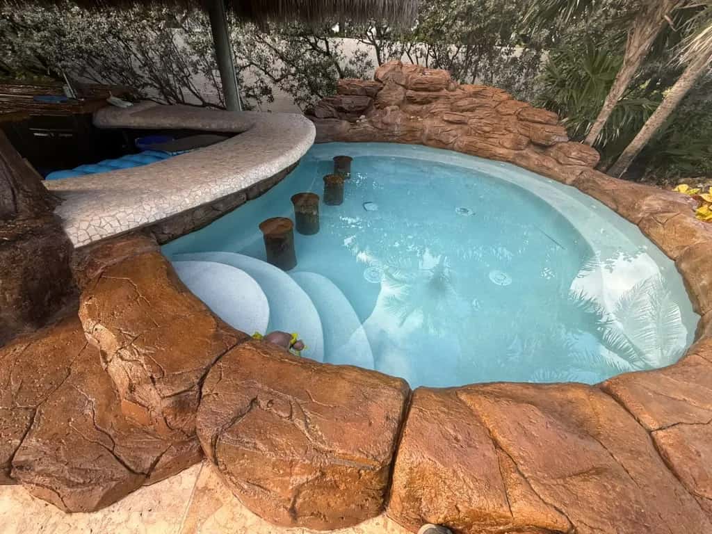 Custom rock grotto spa with sculpted stone edges