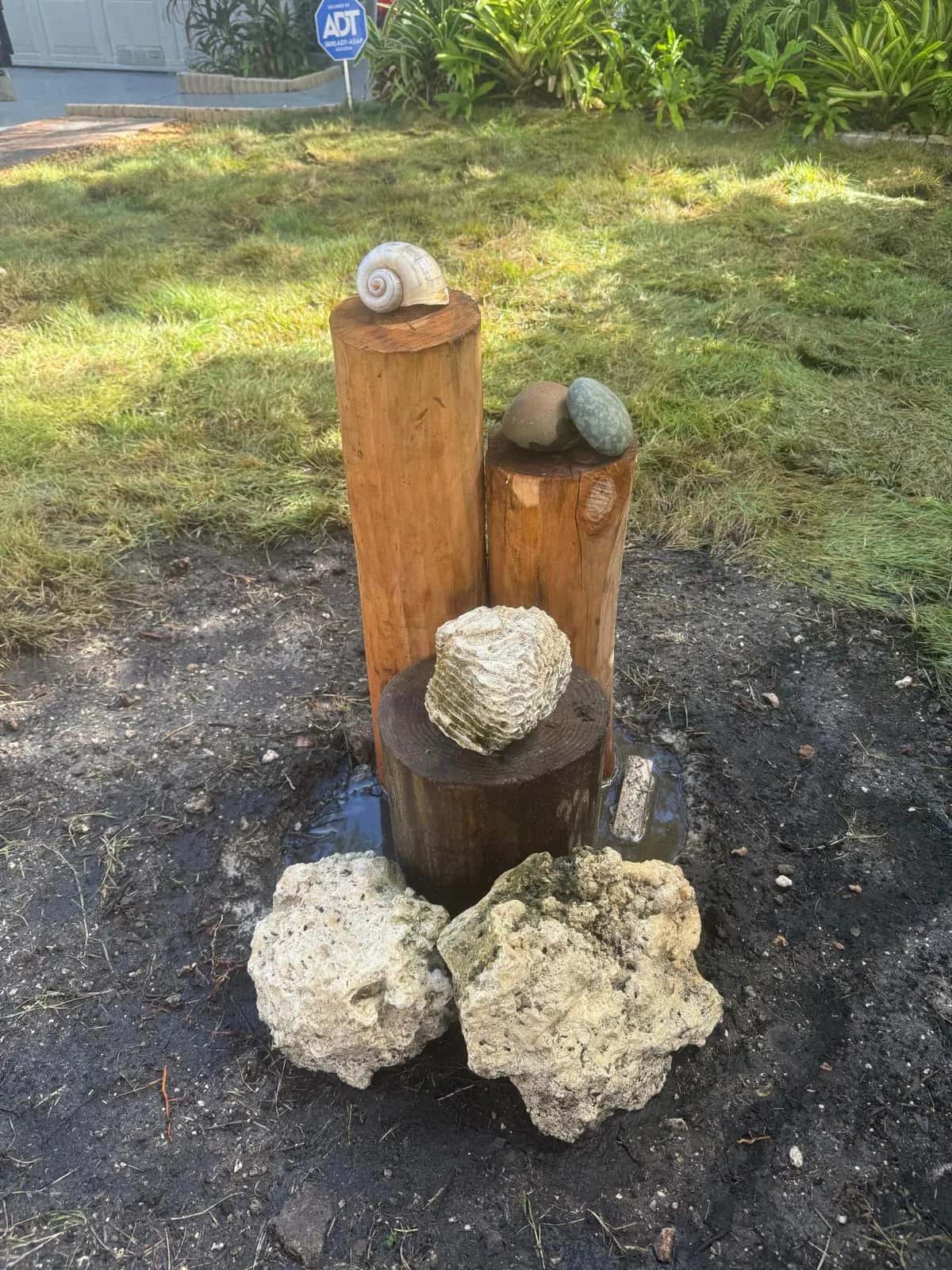 Wood post and coral rock fountain