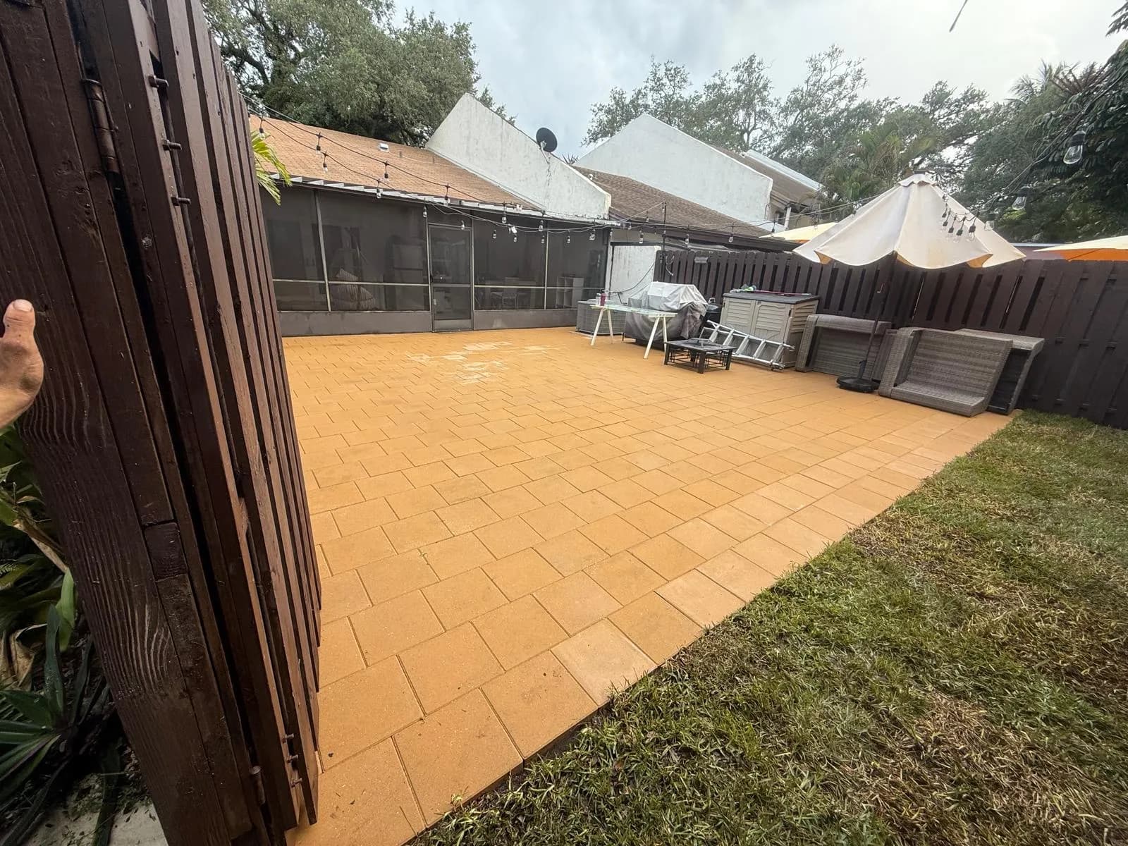 Backyard paver patio restored to warm tan after cleaning — Looking New, serving Oakland Park