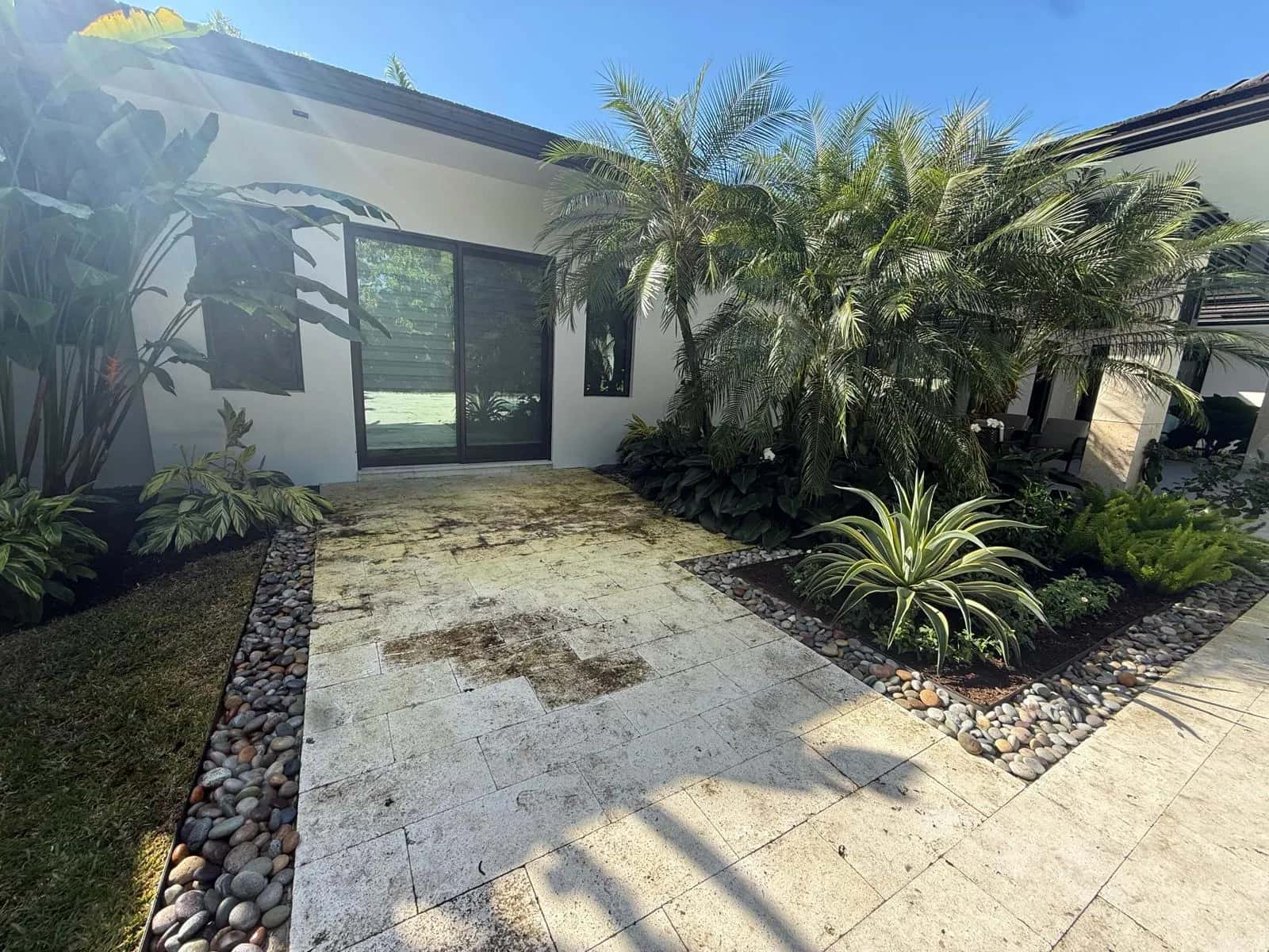 Stained travertine entry walkway before cleaning